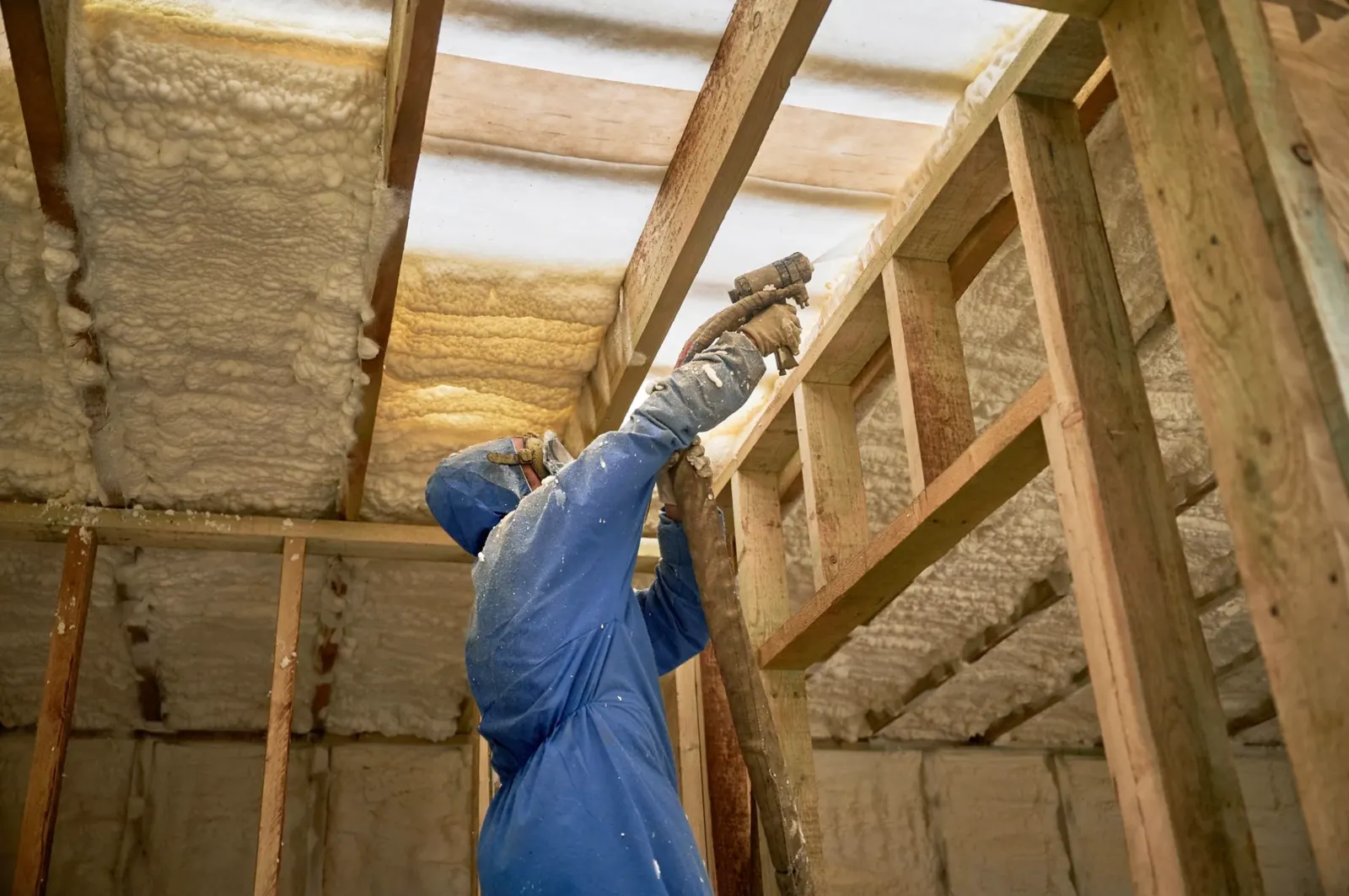 Close view of spray polyurethane foam application at timber roof framing junctions in Markham